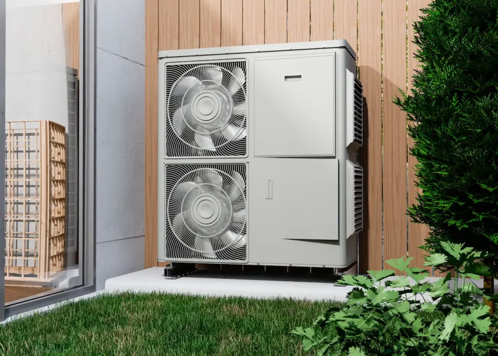 air source heat pump in front of a wall in a garden