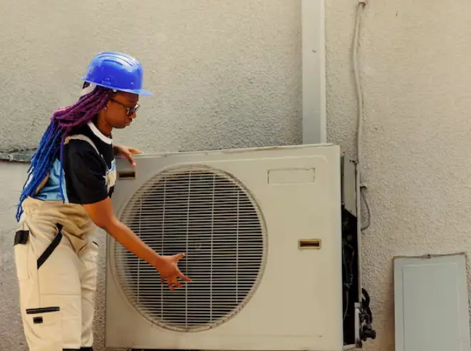 heat pump installation, a heat pump installer is installing a heat pump next to a wall in the uk